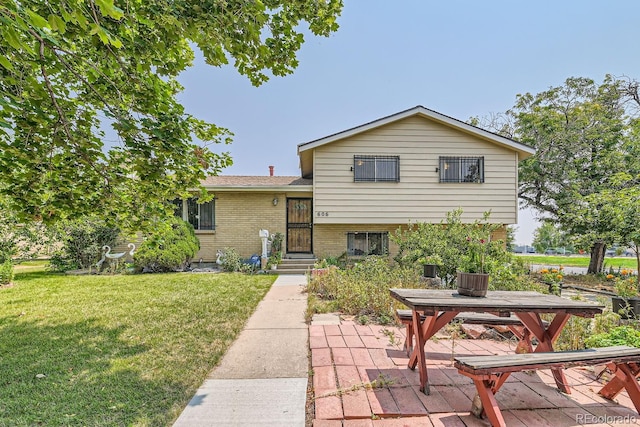 view of front of house with a patio and a front yard