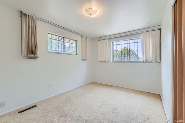 unfurnished room featuring visible vents and carpet flooring