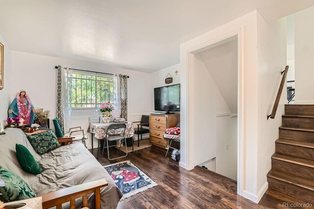 living room with dark hardwood / wood-style flooring