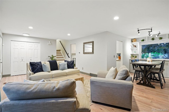 15034 E Floyd Ave, Aurora, CO 80014 - living room featuring stairway, light wood-style floors, and recessed lighting