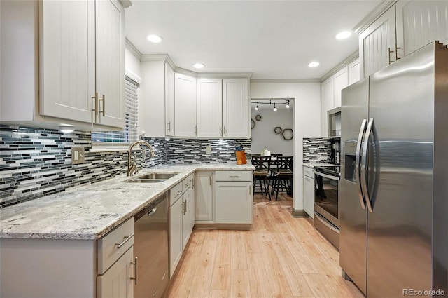 15034 E Floyd Ave, Aurora, CO 80014 - kitchen with appliances with stainless steel finishes, a sink, light wood finished floors, backsplash, and recessed lighting