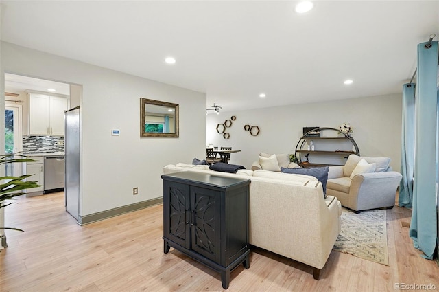 15034 E Floyd Ave, Aurora, CO 80014 - living area featuring light wood-style floors, recessed lighting, and baseboards