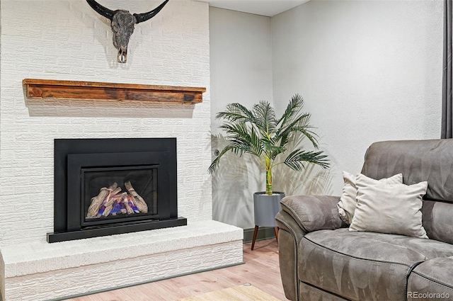 15034 E Floyd Ave, Aurora, CO 80014 - sitting room featuring wood finished floors and a brick fireplace