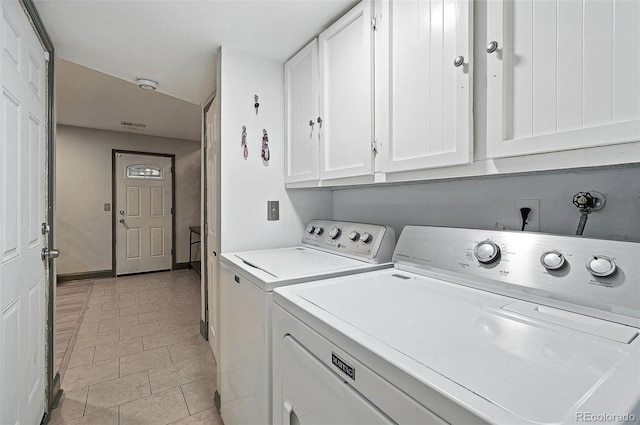 15034 E Floyd Ave, Aurora, CO 80014 - laundry area featuring cabinet space, washing machine and clothes dryer, light tile patterned floors, and baseboards
