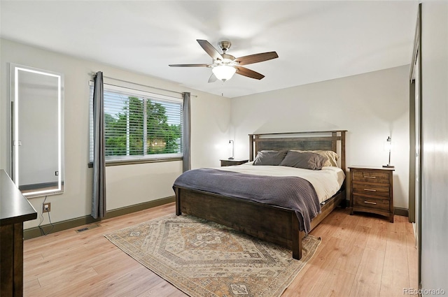 15034 E Floyd Ave, Aurora, CO 80014 - bedroom featuring light wood-style flooring, a ceiling fan, and baseboards