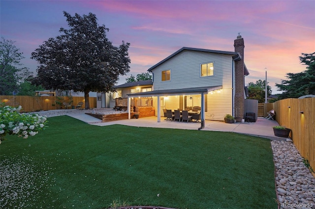 15034 E Floyd Ave, Aurora, CO 80014 - back of house featuring a patio area, a chimney, a gate, and an outdoor living space