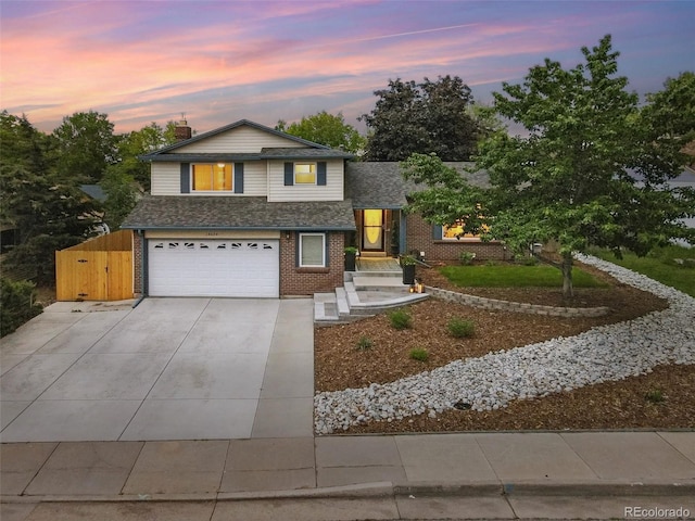 15034 E Floyd Ave, Aurora, CO 80014 - view of front of house featuring an attached garage, concrete driveway, a shingled roof, and brick siding