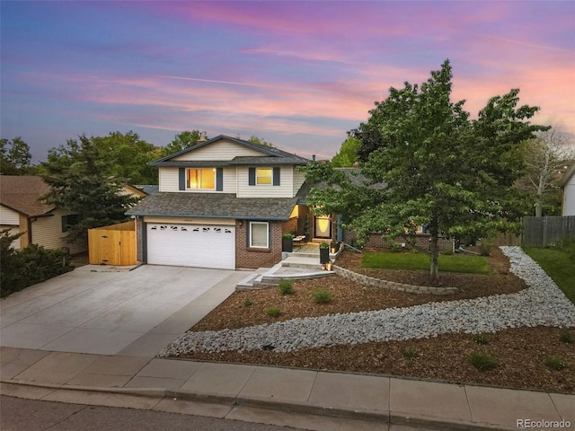 15034 E Floyd Ave, Aurora, CO 80014 - view of front of property featuring an attached garage, brick siding, concrete driveway, and roof with shingles