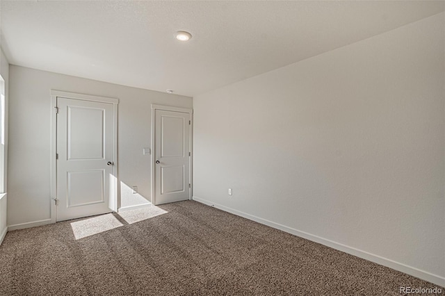 unfurnished bedroom with carpet floors