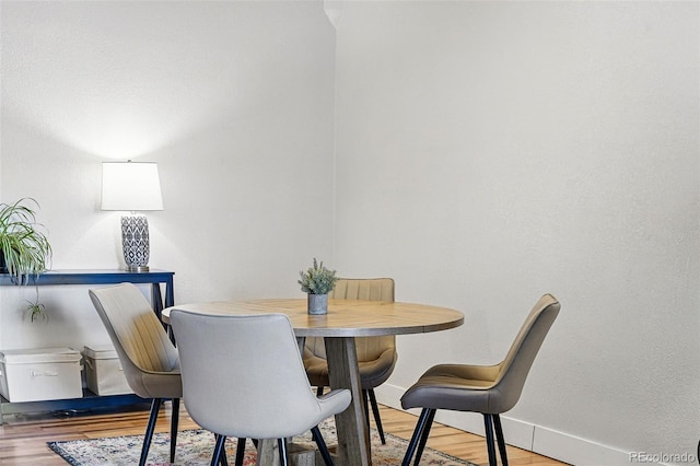 dining area featuring baseboards and wood finished floors
