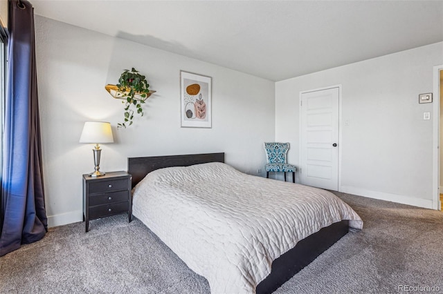 bedroom with baseboards and carpet