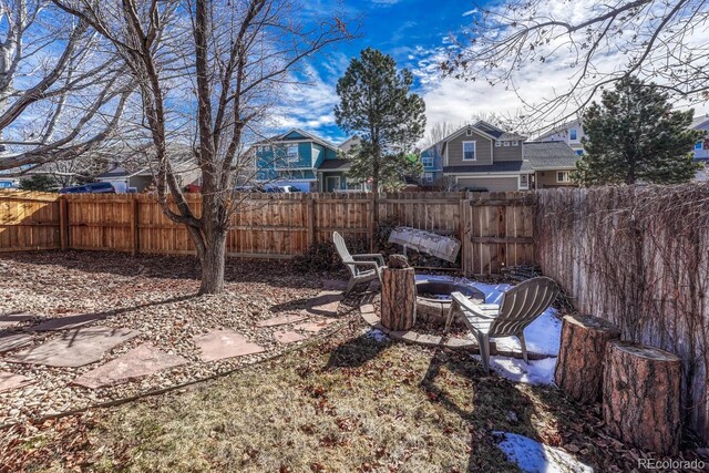 view of yard with an outdoor fire pit and a fenced backyard