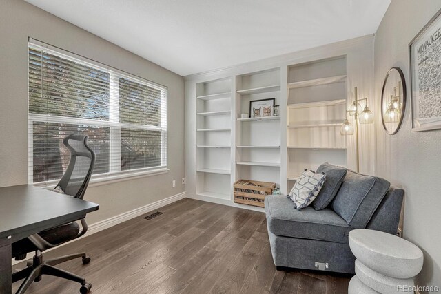 office space featuring built in features, baseboards, visible vents, and dark wood-style flooring