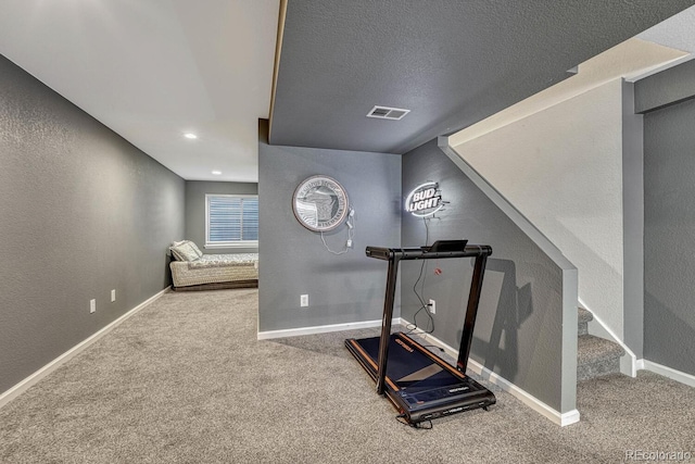 workout area with baseboards, visible vents, a textured wall, a textured ceiling, and carpet floors