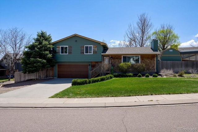 5601 Lantana Cir, Colorado Springs, CO 80915 - split level home with driveway, a garage, and a chimney