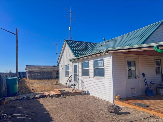 back of property featuring a wooden deck