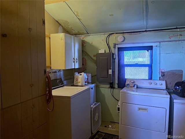 washroom featuring washer and dryer, electric panel, and cabinets