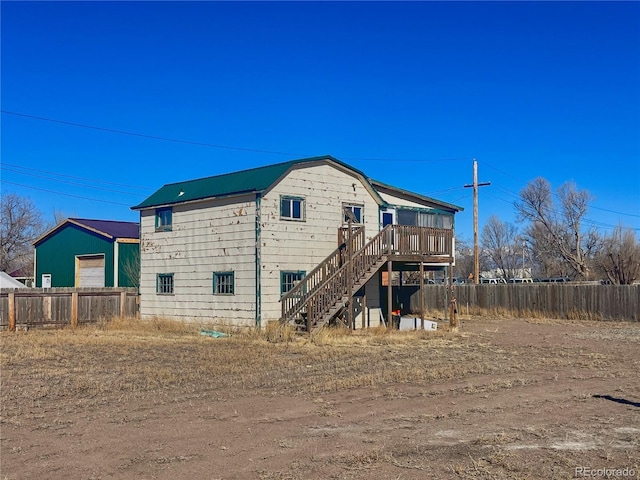 rear view of property featuring a deck