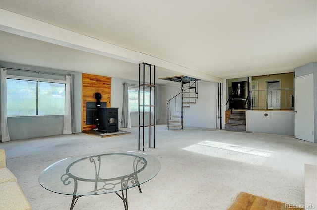 35805 US Highway 24, Buena Vista, CO 81211 - unfurnished living room featuring stairs and a wood stove