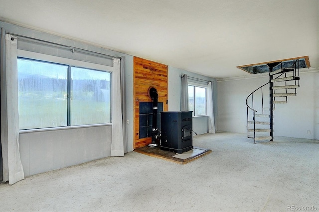 35805 US Highway 24, Buena Vista, CO 81211 - unfurnished living room with a wood stove, stairway, and wooden walls