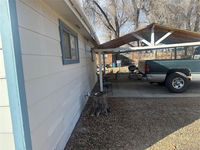 view of car parking featuring a carport and fence