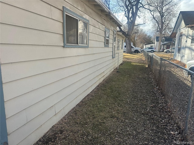 view of side of home featuring a residential view and fence