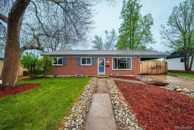 ranch-style home with driveway, a carport, brick siding, and a gate