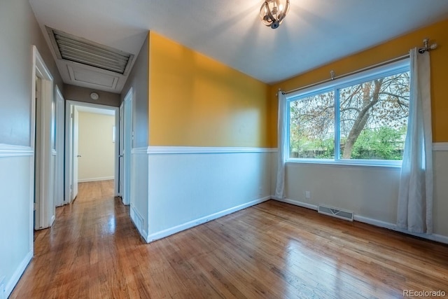 unfurnished room featuring wood finished floors and baseboards