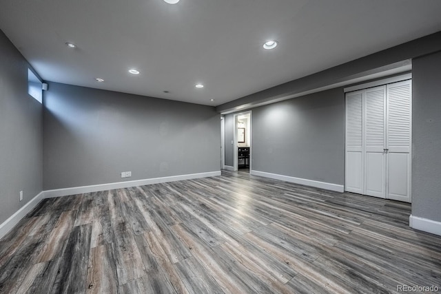 finished basement with wood finished floors, recessed lighting, and baseboards