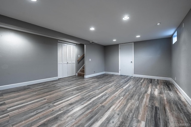 finished below grade area with wood finished floors, stairs, baseboards, and recessed lighting