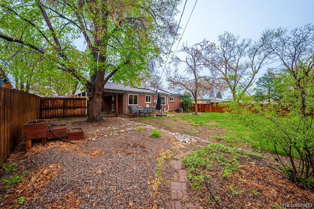 fenced backyard with a patio area