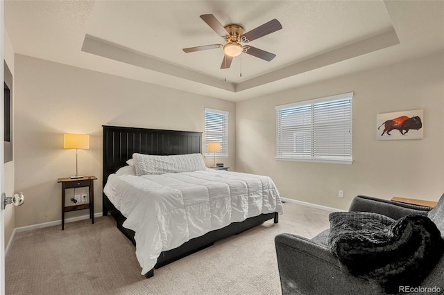 11235 S Neu Towne Cir, Parker, CO 80134 - bedroom featuring a tray ceiling, light carpet, baseboards, and ceiling fan
