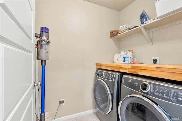11235 S Neu Towne Cir, Parker, CO 80134 - laundry area with washer and dryer, baseboards, and light tile patterned floors