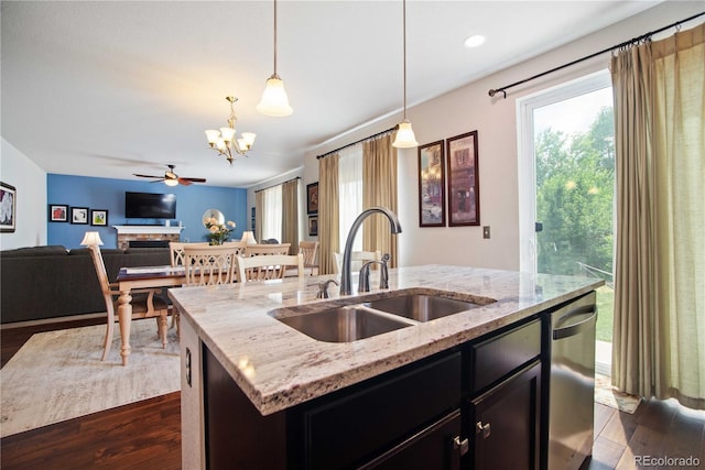 25536 E 1st Ave, Aurora, CO 80018 - kitchen featuring stainless steel dishwasher, open floor plan, dark wood finished floors, a chandelier, and a center island with sink