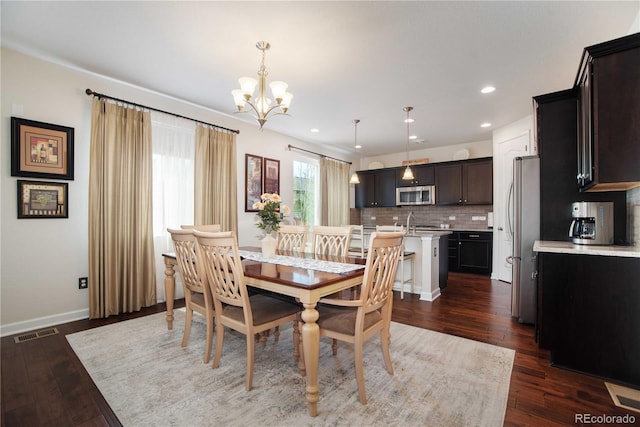 25536 E 1st Ave, Aurora, CO 80018 - dining area featuring a chandelier, dark wood-style floors, and recessed lighting