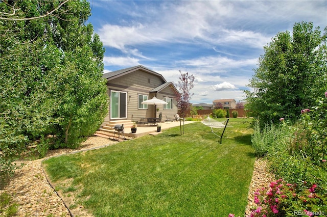 25536 E 1st Ave, Aurora, CO 80018 - view of green lawn featuring entry steps and a patio