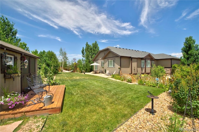 25536 E 1st Ave, Aurora, CO 80018 - view of green lawn featuring a wooden deck and a patio area