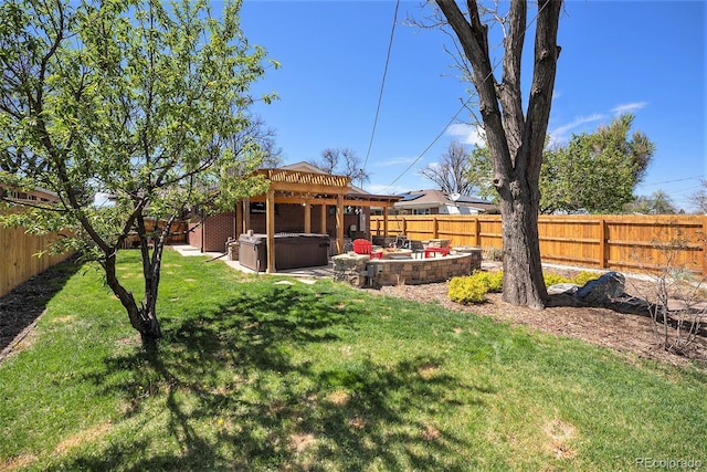 view of yard featuring a hot tub and a fenced backyard