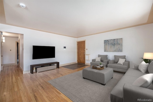 living area featuring baseboards and hardwood / wood-style floors