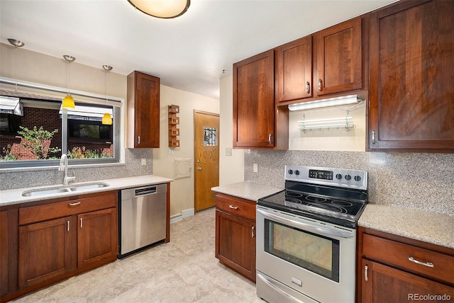 kitchen featuring baseboards, hanging light fixtures, a sink, stainless steel appliances, and tasteful backsplash
