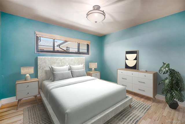 bedroom with light wood finished floors and baseboards