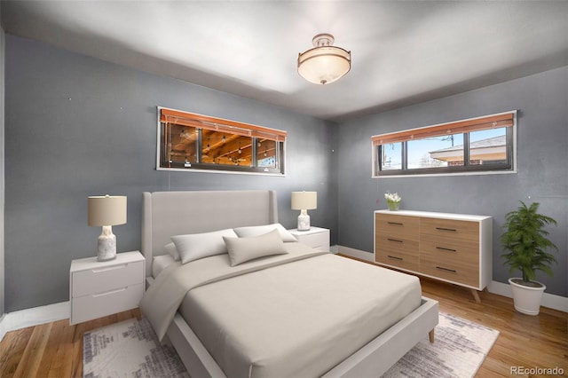 bedroom featuring baseboards and light wood-type flooring