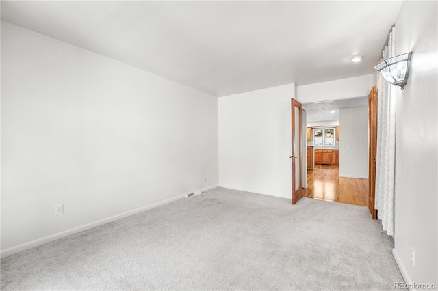 spare room with light wood-type flooring