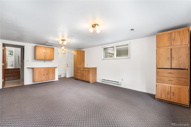 unfurnished living room featuring dark carpet and a baseboard heating unit