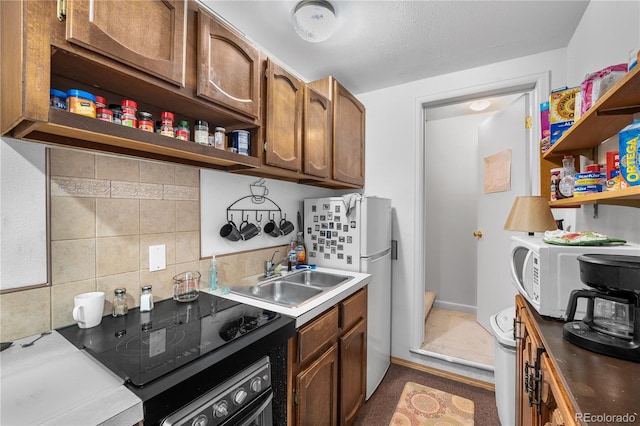 kitchen featuring white appliances, sink, and decorative backsplash