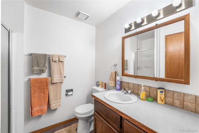 bathroom featuring vanity, toilet, and an enclosed shower