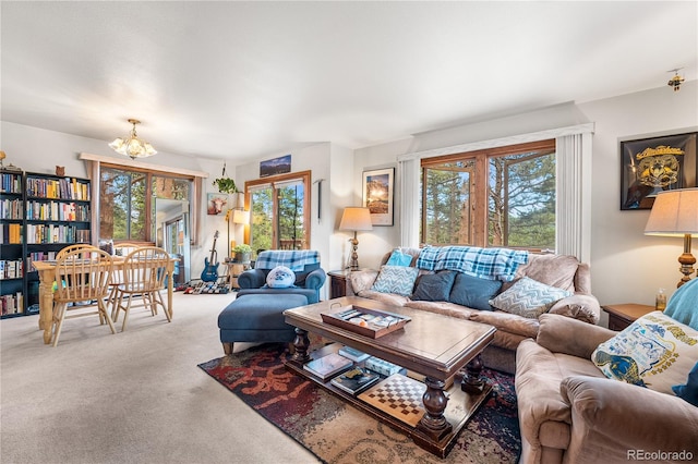 carpeted living room with an inviting chandelier