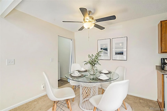 10150 E Virginia Ave Unit 7-302, Denver, CO 80247 - dining area with ceiling fan, baseboards, and light carpet