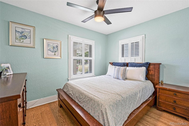 bedroom with ceiling fan and light hardwood / wood-style floors