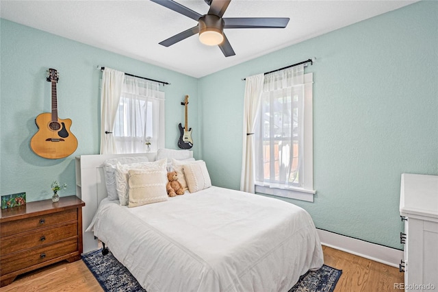 bedroom with ceiling fan and light hardwood / wood-style flooring